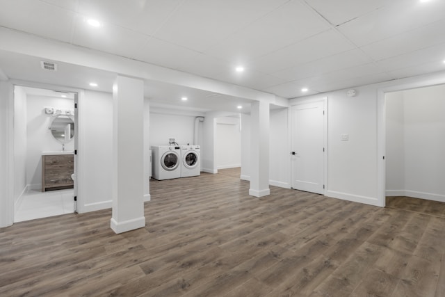 A white basement with a bathroom and laundry room