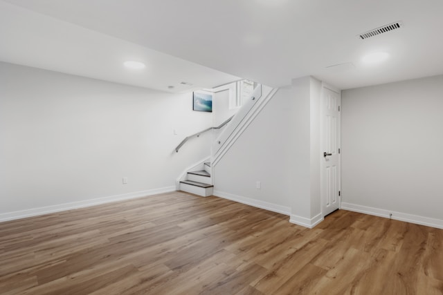 A white basement showing stairs.