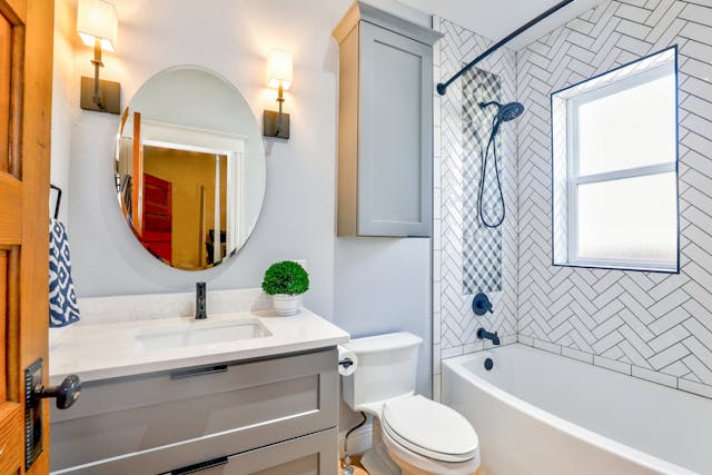 A bathroom with a blue bordered tiles