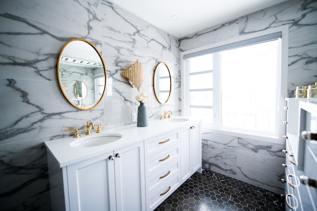 A marble bathroom with gold accents