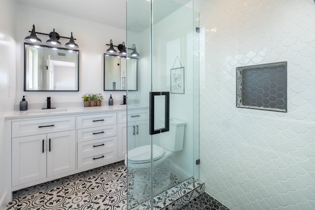 A remodeled bathroom with hexagonal wall tiles