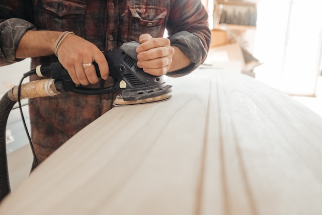 A carpenter sanding wood