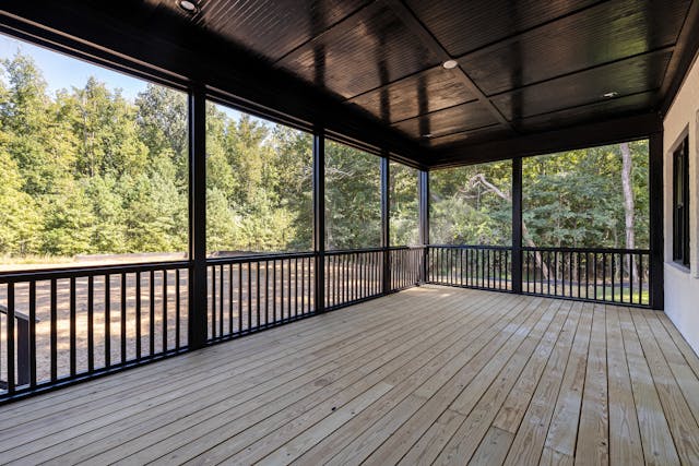 A deck with an open backyard