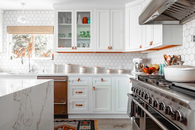 A white kitchen with white hexagonal tiles