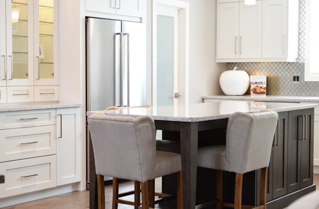 Kitchen with large white marble island countertop