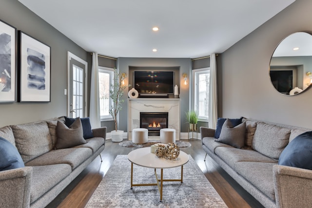 A living room with a gray couch and fireplace